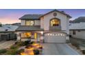 Charming two-story home shows a landscaped front yard and a two-car garage at 781 Wigan Pier Dr, Henderson, NV 89002