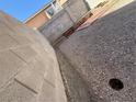 Narrow side yard with a gravel ground cover and block wall at 8049 Celestial Ave # 201, Las Vegas, NV 89128
