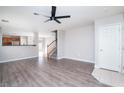 Open-concept living room featuring hardwood floors, neutral paint, and a ceiling fan at 8174 Amphora St, Las Vegas, NV 89139
