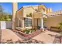 Inviting front yard with colorful flowers, brick accents, and a welcoming entryway at 8308 Tide Pool Dr, Las Vegas, NV 89128