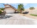 Single-Gathering home with a two-car garage, desert landscaping, and a spacious driveway, perfect for families at 8345 Spruce Meadows Ave, Las Vegas, NV 89131