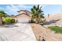 Inviting single-Gathering home featuring a spacious driveway, desert landscaping, and a two-car garage at 8345 Spruce Meadows Ave, Las Vegas, NV 89131