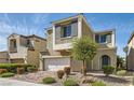 Beautiful two-story house featuring a two-car garage, desert landscaping and a blue entry door at 9020 Tiffany Oaks Ave, Las Vegas, NV 89148