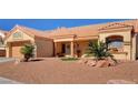 Single-story home with a desert-style yard featuring rock landscaping, desert plants and a terracotta roof at 9912 Woodhouse Dr, Las Vegas, NV 89134