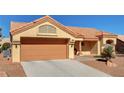 Exterior of home showing a terracotta roof, light colored exterior paint and desert landscaping at 9912 Woodhouse Dr, Las Vegas, NV 89134
