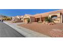 Inviting street view with desert landscaping, terracotta roofs, and houses in the neighborhood at 9912 Woodhouse Dr, Las Vegas, NV 89134