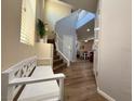 Inviting foyer features wood flooring and a staircase to the second floor at 10271 Headrick Dr, Las Vegas, NV 89166