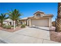 Inviting single-story home features a well-manicured lawn, desert landscaping, and a spacious two-car garage at 1043 Armillaria St, Henderson, NV 89011