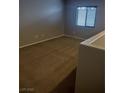 Bedroom featuring neutral walls and carpet, with natural light coming through a window at 10609 Sand Mountain Ave, Las Vegas, NV 89166