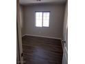 Bedroom with modern flooring, neutral walls, and ample natural light from a window at 10609 Sand Mountain Ave, Las Vegas, NV 89166