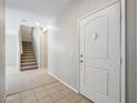 Bright entryway with tile flooring, leading to the staircase and other rooms at 10609 Sand Mountain Ave, Las Vegas, NV 89166