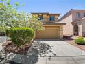 Two-story home featuring an attached two-car garage, mature landscaping, and neutral color scheme at 10609 Sand Mountain Ave, Las Vegas, NV 89166
