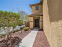 Inviting front entrance with a walkway leading to the front door and decorative rock landscaping at 10609 Sand Mountain Ave, Las Vegas, NV 89166