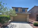 Two-story home featuring a two-car garage and a well-maintained front yard at 10609 Sand Mountain Ave, Las Vegas, NV 89166