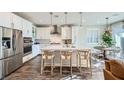 Bright kitchen features stainless appliances, an island with seating, and pendant lighting at 12532 Blissful Sky St, Las Vegas, NV 89138