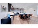 Modern kitchen features dark wood cabinets, stainless steel appliances, and a large island with seating at 1319 Yosemite St, Boulder City, NV 89005