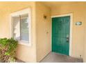 Inviting entryway features a secure green door and a manicured shrub adding a touch of nature at 1400 Jamielinn Ln # 104, Las Vegas, NV 89110