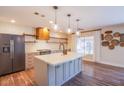 Modern kitchen with center island, stainless steel appliances, and decorative shelving at 1508 Silver Knoll Ave, Las Vegas, NV 89123