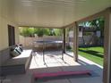 View of the covered patio, play equipment, and synthetic backyard lawn at 1508 Silver Knoll Ave, Las Vegas, NV 89123