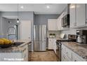 Well-equipped kitchen featuring modern appliances, granite countertops and ample cabinet space at 165 Calm Morning Ave, Henderson, NV 89002
