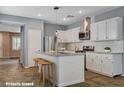 Modern kitchen featuring granite countertops, white cabinets, and stainless steel appliances at 165 Calm Morning Ave, Henderson, NV 89002
