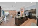 Spacious kitchen with a large island, dark cabinetry, and modern appliances at 2104 Leatherbridge Ct, North Las Vegas, NV 89081