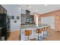Kitchen with granite countertops, stainless appliances, pendant lighting, and stylish barstool seating at 2104 Leatherbridge Ct, North Las Vegas, NV 89081