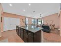 Kitchen island features a granite countertop, a sink, and is ideal for food preparation and casual dining at 2104 Leatherbridge Ct, North Las Vegas, NV 89081