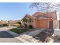 Inviting home with a well-maintained lawn, desert landscaping, and a two-car garage at 2143 Vista Famosa Ct, Las Vegas, NV 89123