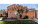 Beautiful home featuring desert landscaping, an attached two-car garage, and a tiled roof at 2143 Vista Famosa Ct, Las Vegas, NV 89123