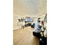 Inviting living room with fireplace, wood-look flooring, and access to a balcony or patio at 221 Mission Newport Ln # 205, Las Vegas, NV 89107