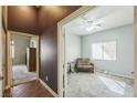 Serene bedroom with soft carpet, a ceiling fan, and a view into another room, promoting a calming atmosphere at 250 Aspen Bay Ln, Henderson, NV 89012