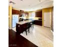 Kitchen featuring dark wood cabinets, granite countertops, and a center island at 2539 Early Light Dr, Las Vegas, NV 89142