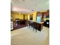 Open kitchen featuring a center island, dining area, and views to the living spaces at 2539 Early Light Dr, Las Vegas, NV 89142