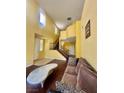 Bright living room with high ceilings, wood floors, staircase and ample natural light at 2539 Early Light Dr, Las Vegas, NV 89142