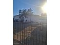 The front of this home has a barred front door and window, xeriscaping, and a dark iron fence at 2888 El Cajon St, Las Vegas, NV 89169