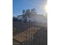 The front of this home has a barred front door and window, xeriscaping, and a dark iron fence at 2888 El Cajon St, Las Vegas, NV 89169