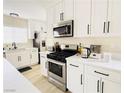 Well-lit kitchen with stainless steel appliances, sleek white cabinetry, and modern countertops at 2925 Wigwam Pkwy # 724, Henderson, NV 89074