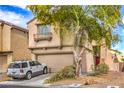 Two-story home with a tan exterior, a two-car garage, and minimal landscaping at 3568 Gloucester Gate St, Las Vegas, NV 89122