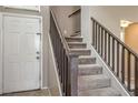 View of a carpeted staircase with wood railing leading to the upper level of the home at 3568 Gloucester Gate St, Las Vegas, NV 89122