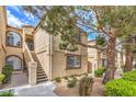 Charming condo building featuring well-maintained landscaping and inviting exterior staircase at 3660 Renovah St # 202, Las Vegas, NV 89129