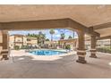 Community pool and lounging area framed by covered seating and building exterior at 3660 Renovah St # 202, Las Vegas, NV 89129