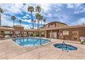 Sparkling community pool with hot tub, surrounded by palm trees and a lounging area at 3660 Renovah St # 202, Las Vegas, NV 89129