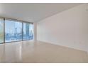 Minimalist living room featuring tile flooring and city views through large window at 3726 S Las Vegas Blvd # 1003, Las Vegas, NV 89158
