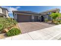 Beautiful home with a three-car garage, stone accents, and meticulously maintained desert landscaping at 3817 Grazing Gazelle Ave, North Las Vegas, NV 89084