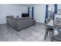 Bright living room with sleek gray flooring, modern furniture, and ample natural light at 3934 Palos Verdes St, Las Vegas, NV 89119