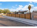 Charming single-story home featuring a modern horizontal wood fence and a well-maintained front yard at 5208 Overland Ave, Las Vegas, NV 89107