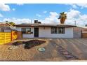 This home features a desert landscaped yard, solar panels and a wooden fence at 5208 Overland Ave, Las Vegas, NV 89107