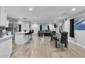 Bright, open-concept living space with a large island, stainless steel appliances, and a dining area at 5208 Overland Ave, Las Vegas, NV 89107