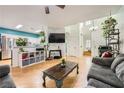 Open-concept living room with hardwood floors, lots of natural light, and modern furnishings at 5853 Gentleslope St, Henderson, NV 89011